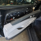 Peeling away the door panel.